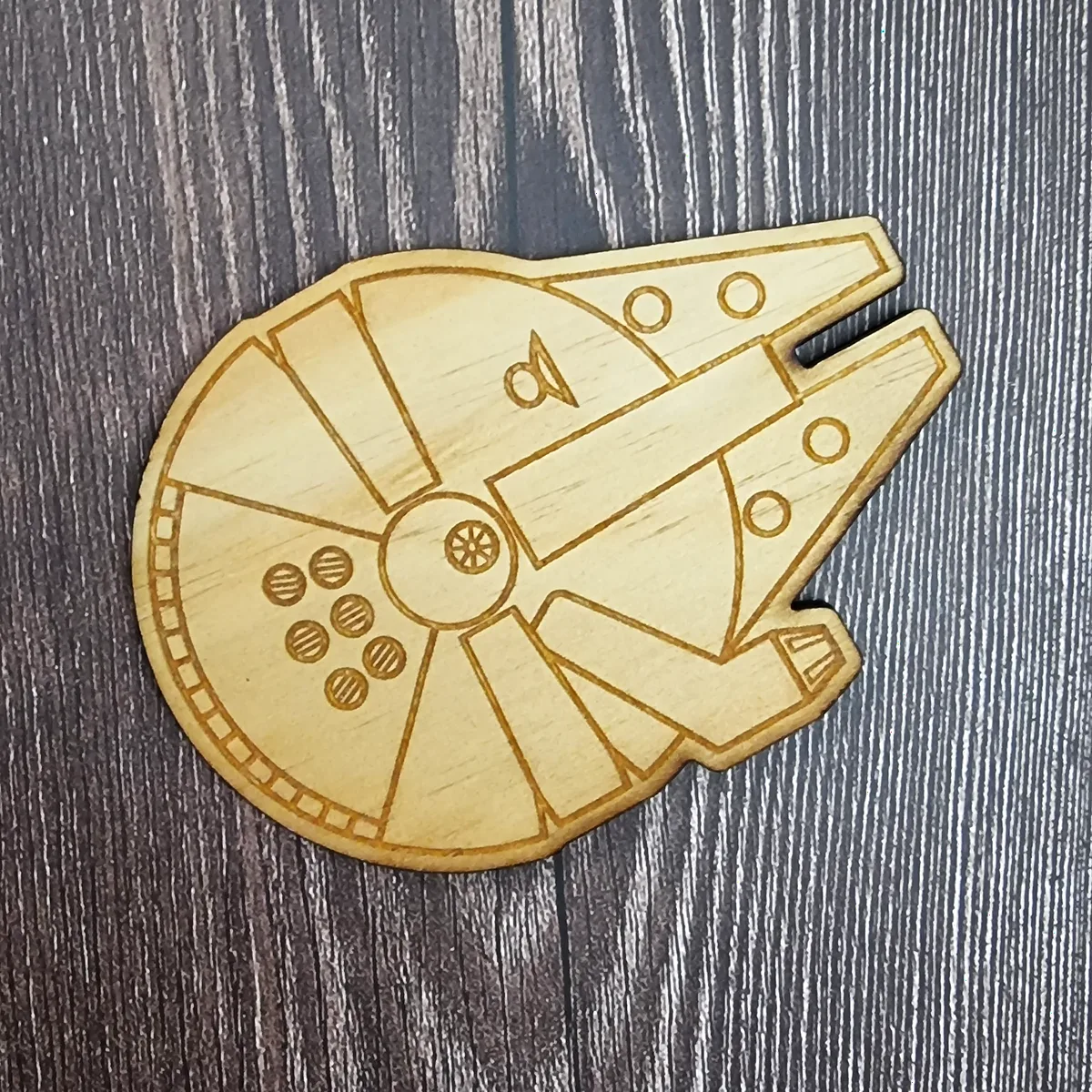 Millennium Falcon-shaped coaster, laser cut and engraved in natural timber